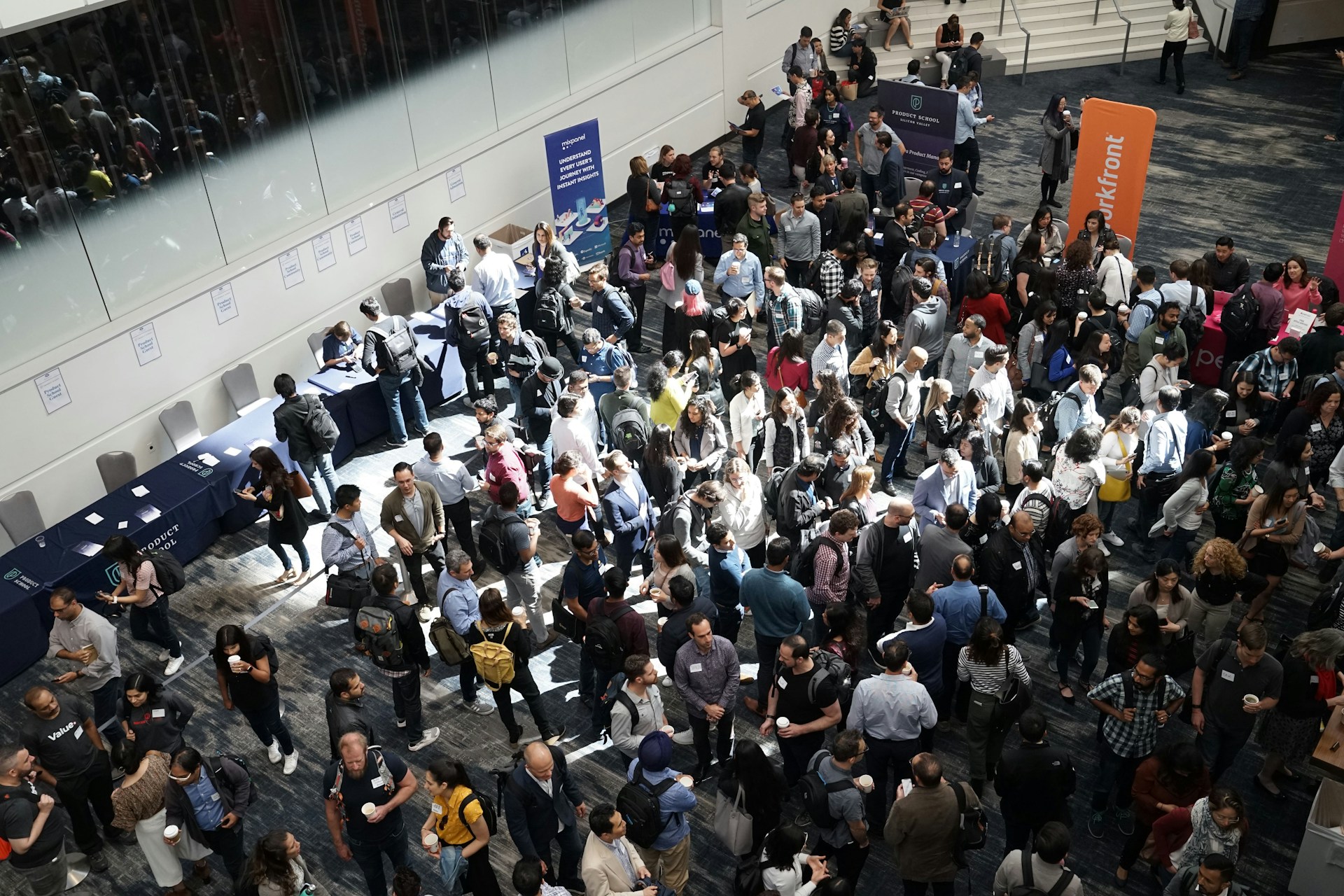 Overhead view of a busy conference expo hall with attendees networking